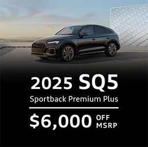 Side view of an Audi Q7 driving.